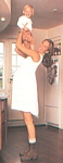 ital. Village May 1996 - pregnant lifting baby Ulrikke in the kitchen